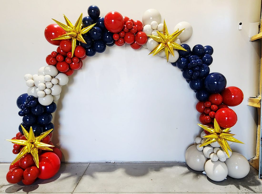 Navy, ivory and red balloon arch accented with star balloons